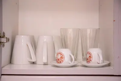a shelf with white cups and vases on it at Athens Best location, 6 Ermou street, Syntagma square in Athens
