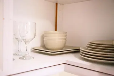 two wine glasses and plates on a kitchen counter at Athens Best location, 6 Ermou street, Syntagma square in Athens