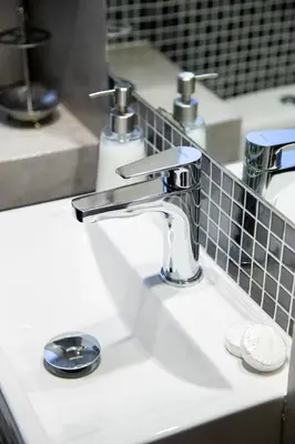 a white bathroom sink with a chrome faucet at Athens Best location, 6 Ermou street, Syntagma square in Athens