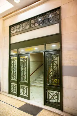 an entrance to a building with two revolving doors at Athens Best location, 6 Ermou street, Syntagma square in Athens