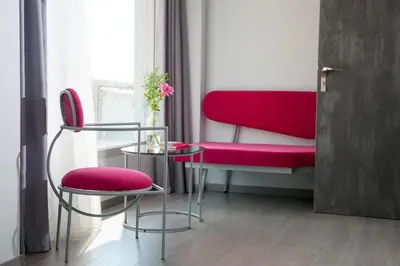 a room with red chairs and a table and a window at Athens Utopia Ermou in Athens