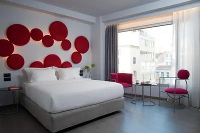 a bedroom with a large bed with red plates on the wall at Athens Utopia Ermou in Athens