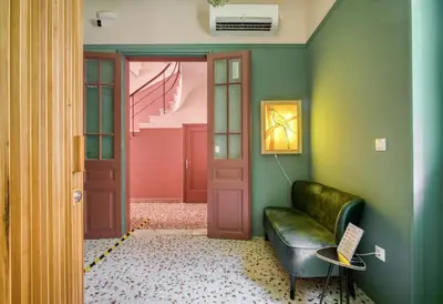 a living room with a couch and a door at KERAMOS Athens in Athens