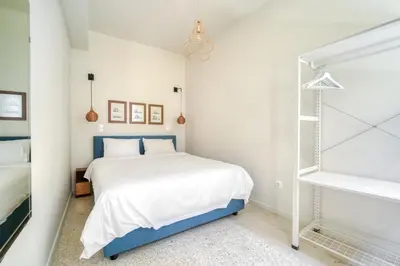 a bedroom with a blue and white bed at KERAMOS Athens in Athens
