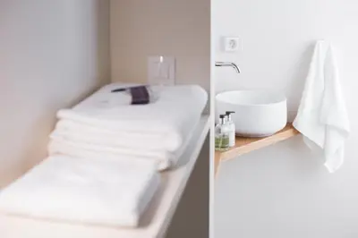 a bathroom with a sink and a pile of towels at KERAMOS Athens in Athens