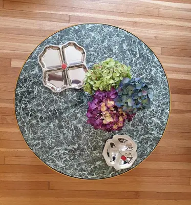 a glass table with flowers on top of a wooden floor at KERAMOS Athens in Athens