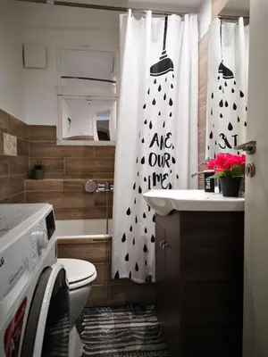 a bathroom with a toilet and a shower curtain at Sea&Sun Glyfada Apartment in Athens