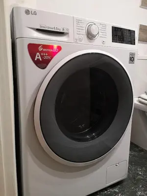 a white washing machine with a red sticker on it at Sea&Sun Glyfada Apartment in Athens