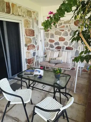 a patio with a table and chairs and a couch at Sea&Sun Glyfada Apartment in Athens