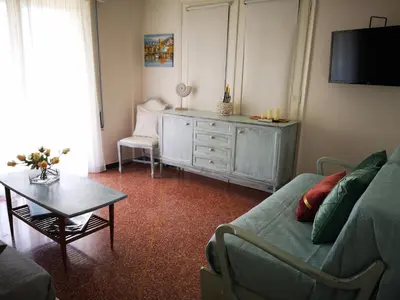 a living room with a green couch and a table at Sea&Sun Glyfada Apartment in Athens