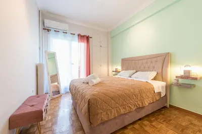 a bedroom with a large bed and a mirror at Gorgeous & Modern At Ampelokipi Metro Station By Greece Apartments in Athens