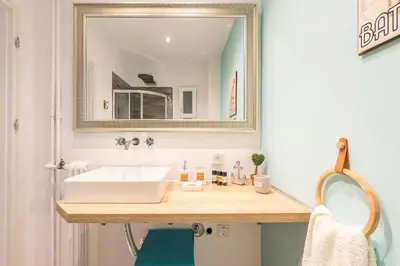 a bathroom with a white sink and a mirror at Gorgeous & Modern At Ampelokipi Metro Station By Greece Apartments in Athens