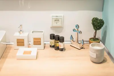 a wooden counter with cosmetics and other items on it at Gorgeous & Modern At Ampelokipi Metro Station By Greece Apartments in Athens