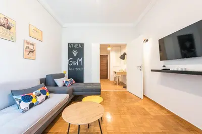 a living room with a couch and a table at Gorgeous & Modern At Ampelokipi Metro Station By Greece Apartments in Athens