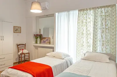 a bedroom with two beds next to a window at Marveco Apartment in Athens