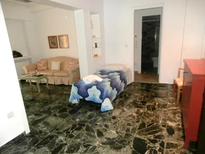 a living room with a couch and a table at Marveco Apartment in Athens