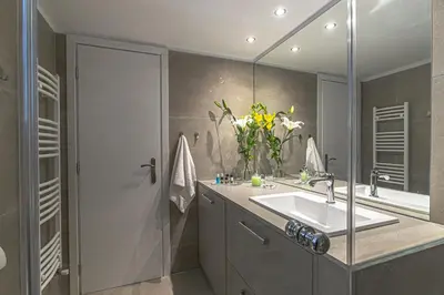 a bathroom with a sink and a mirror at Marveco Apartment in Athens