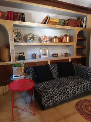a living room with a couch and a red stool at Garden's House in Spáta
