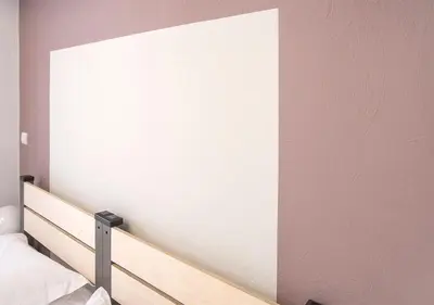 a bedroom with a striped wall with a bed at Snooze H in Athens