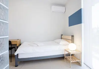 a small bedroom with a bed and a table at Snooze H in Athens