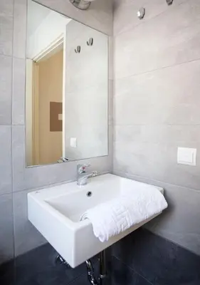 a bathroom with a white sink and a mirror at Snooze H in Athens
