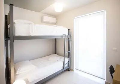 a bedroom with two bunk beds and a mirror at Snooze H in Athens