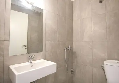 a bathroom with a sink and a toilet and a mirror at Snooze H in Athens