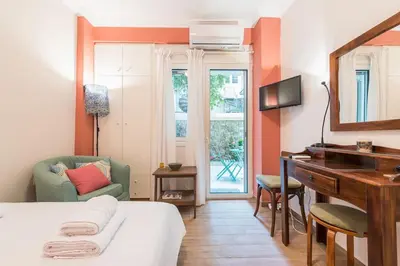 a room with a bed and a desk and a mirror at Cozy studio 5mins walk from Acropolis museum in Athens