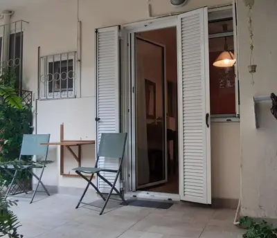 a pair of chairs sitting in front of a door at Cozy studio 5mins walk from Acropolis museum in Athens