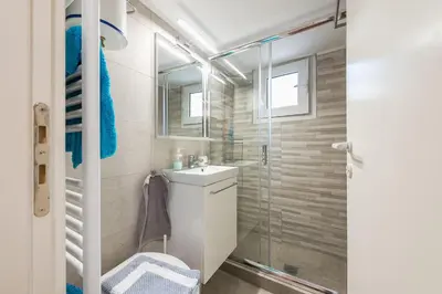 a bathroom with a sink and a shower at Cozy studio 5mins walk from Acropolis museum in Athens