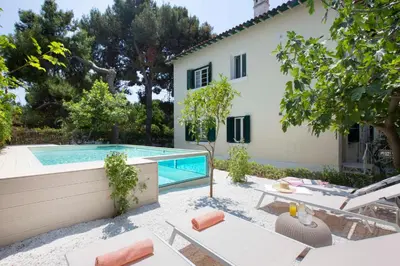 a villa with a swimming pool and a house at Glyfada Villa 6BR 16ppl Private Pool 300m to Beach in Athens