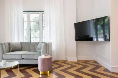a living room with a couch and a tv at Glyfada Villa 6BR 16ppl Private Pool 300m to Beach in Athens