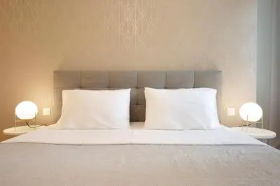a bed with two white pillows and two lamps at Glyfada Villa 6BR 16ppl Private Pool 300m to Beach in Athens