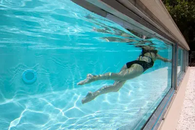 a person is swimming in a swimming pool at Glyfada Villa 6BR 16ppl Private Pool 300m to Beach in Athens