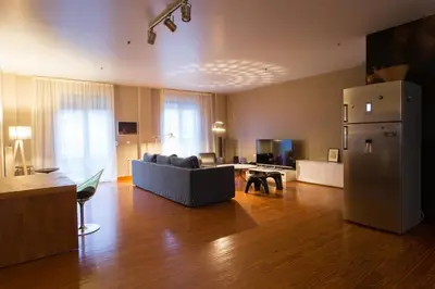 a living room with a couch and a refrigerator at ACROPOLITANA 2 in Athens