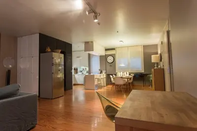 a kitchen and living room with a couch and a table at ACROPOLITANA 2 in Athens
