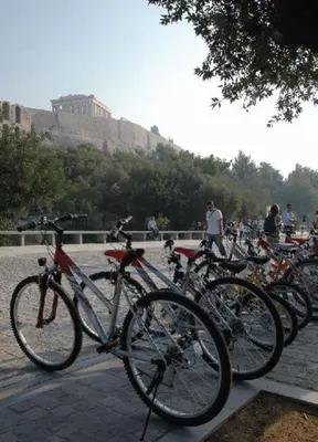 a bunch of bikes parked in a row on a sidewalk at ACROPOLITANA 2 in Athens