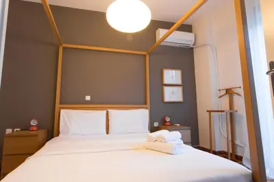 a bedroom with a bed with two towels on it at ACROPOLITANA 2 in Athens