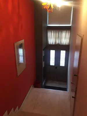 a room with red walls and a door with a window at ACROPOLITANA 2 in Athens