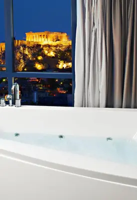 a bathroom window with a view of the acropolis at BEAUTIFUL PEOPLE SUITES ATHENS ACROPOLIS VIEW in Athens