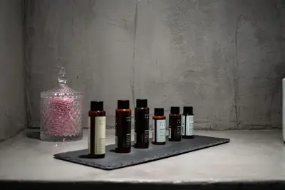 a group of bottles of essential oils sitting on a table at BEAUTIFUL PEOPLE SUITES ATHENS ACROPOLIS VIEW in Athens