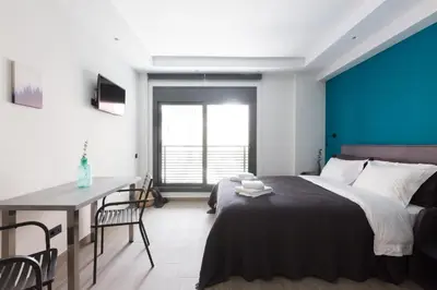 a bedroom with a large bed and a table and chairs at 12 Reasons Why Metaxourgeio in Athens
