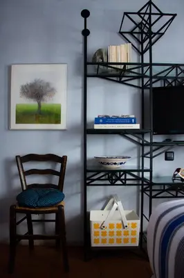 a room with a book shelf and a chair at Villa Rosa with private pool, Athens Riviera in Kalívia Thorikoú