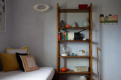 a room with a bed and a book shelf at Villa Rosa with private pool, Athens Riviera in Kalívia Thorikoú
