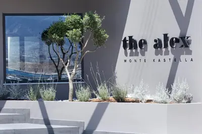 a building with a tree in front of a window at The Alex Monte Kastella, Santikos Collection in Piraeus