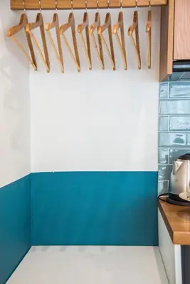 a kitchen with blue and white walls and wood accents at Rastoni Athens Suites near Acropolis at Tsatsou street in Athens