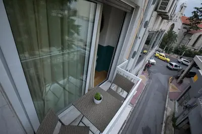 a balcony with a potted plant sitting on a table at Rastoni Athens Suites near Acropolis at Tsatsou street in Athens