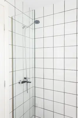 a bathroom with a shower with a glass door at Urban Athens Apartment in Athens