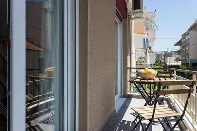 a balcony with a table and a bowl of fruit at Urban Athens Apartment in Athens