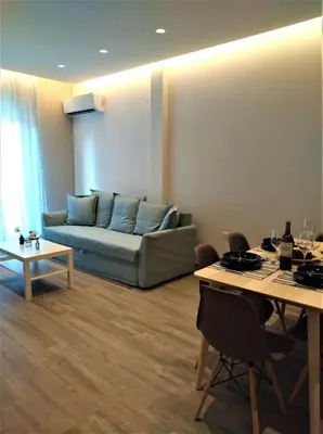 a living room with a couch and a table at More Athens Apartments in Athens